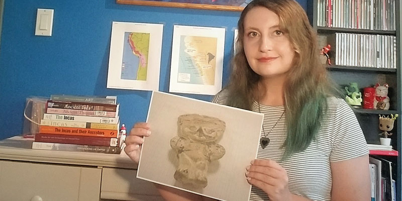  Rebecca Wagener, '21, with a photo of one of the nine artifacts she researched for her summer FURSCA project. Wagener is a senior majoring in anthropology and art history with minors in geology and history. Wagener is the child of Claudia and Tony Wagener of Shelby Township and a graduate of Eisenhower High School. 