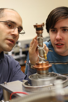 Albion College physics professor Aaron Miller works with a student.