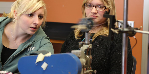 Albion College students conduct an exercise in a physics lab.