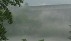 Early morning mists shroud Fontana Dam, built to provide power to war industries, including Oak Ridge, in the 1940's