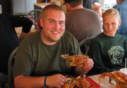 Alex enjoys boiled crab at Harris Crab House.  Owner Karen Ortel gave her perspectives on bay issues, challenging scientists for endlessly seeking grants rather than action, and environmentalists for being too cautious about introducing Pacific oysters