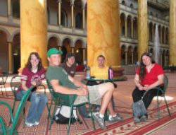 Students relax in the National Building Museum after visiting the display on green building