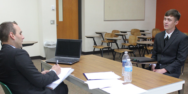 A student and a potential employer during a mock interview. 