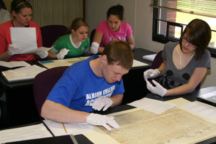 Albion College history students handling and studying original documents.