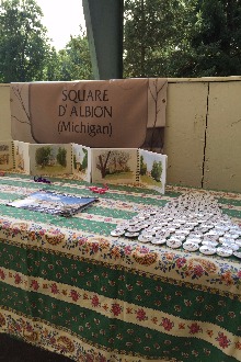 A sign reading 'Square D' Albion (Michigan)' with buttons and literature laid out. 
