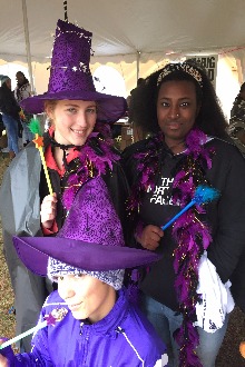 Student's in purple witch hats, holding wands. 