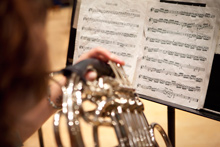 An Albion College music student practices the French horn.
