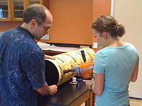 Physics professor Aaron Miller and Holly Farris drill a portion of the telescope
