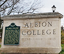 Albion College sign with State of Michigan historical marker at the Michigan Avenue entrance to campus.