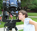 Viewing the August 21, 2017 solar eclipse through a telescope on the Albion College Quadrangle.