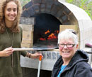 Albion College women's and gender studies professor Trisha Franzen and a student in front of the pizza oven Franzen's first-year seminar class built.