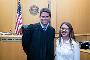 Albion College student Sarah Brittan, '20, with Michigan 44th District Court Judge Derek Meinecke.
