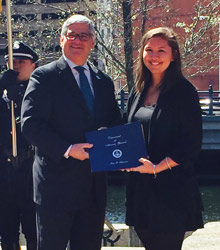 Rebekah Snyd4er. '14, was honored for her advocavcy work with sexual assault victims by Rhode Island attorney general Peter KIlmartin.