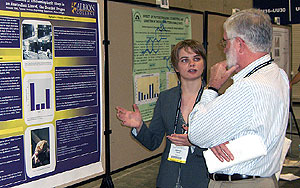 Amanda Tilot, '09, discusses her research with University of Michigan neurophysiologist Robert Bradley, father of alumna Anna Mistretta-Bradley, '05.