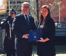 Rebekah Snyder. '14, receives an award from Rhode Island attorney general Peter Kilmartin. 
