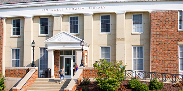 Two students entering the Stockwell-Mudd Library via the steps.