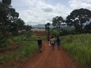 Students walk down a rural road. 