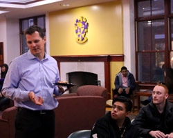 Albion College Visiting Scholar Austin Baidas, '92 (standing), talks with students in the Kellogg Center.