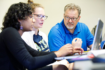 Dr. David Reimann, professor of mathematics and computer science, advises Albion students in a 2019 photo.