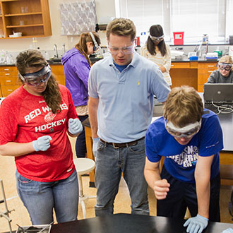 Brad Rabquer (center), associate professor of biology and co-director of the Institute for Healthcare Professions, works with students in the College's Physiology Lab.